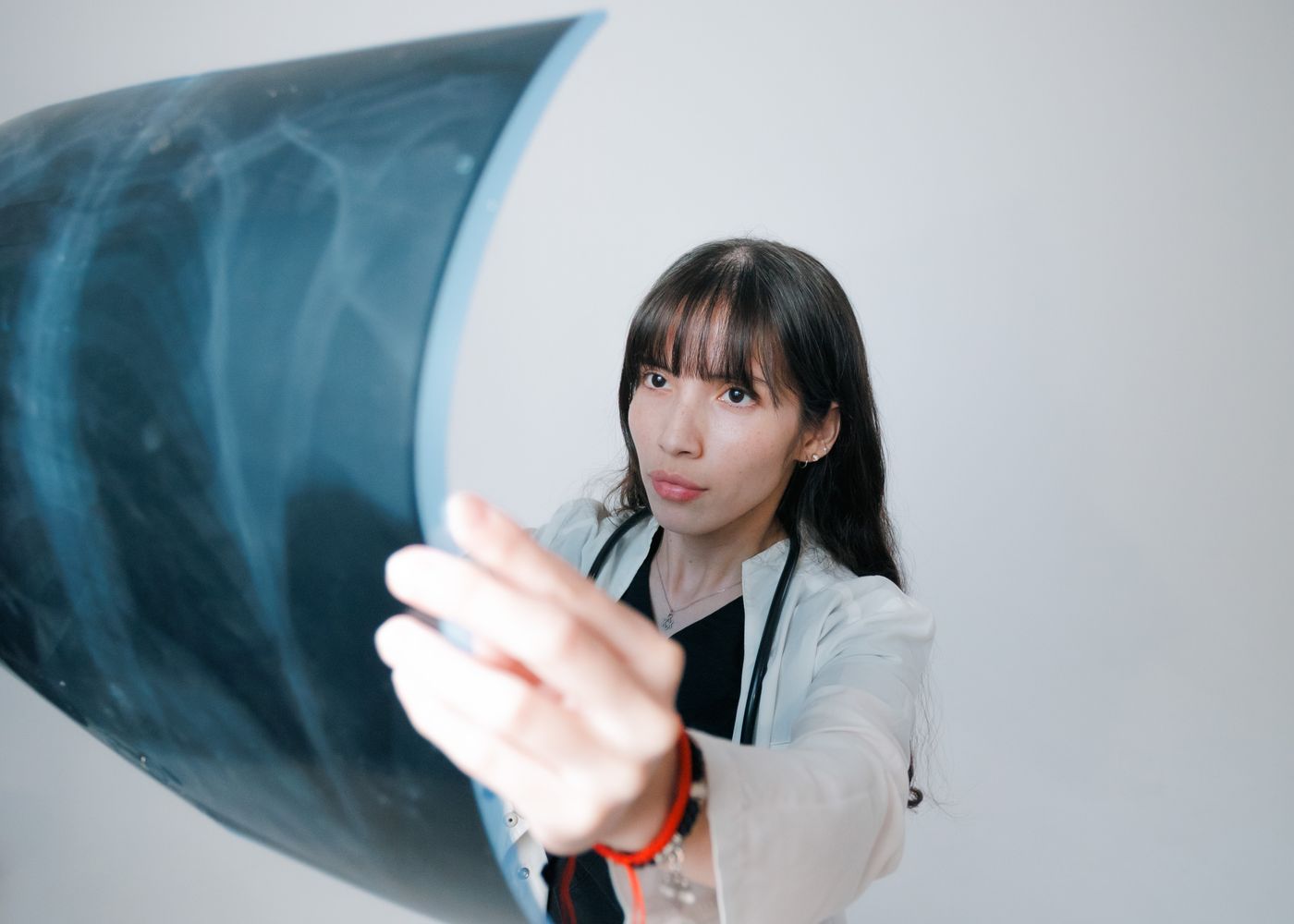 A doctor holding up an X-ray film to examine it